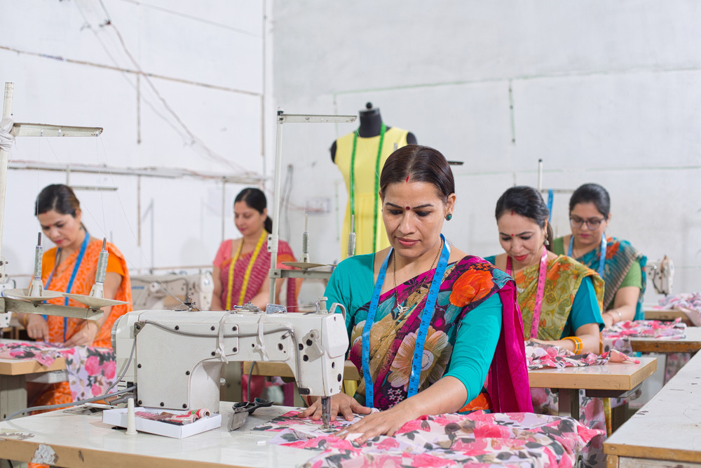 Woman,Textile,Worker,Using,Sewing,Machine,On,Production,Line